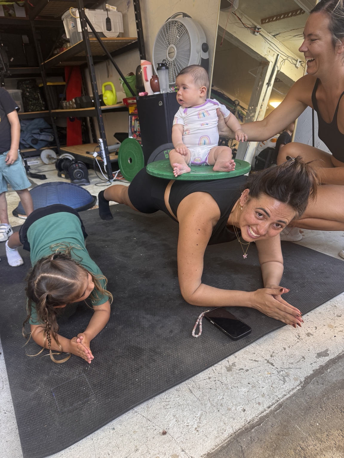 Women and children together during a garage gym training session